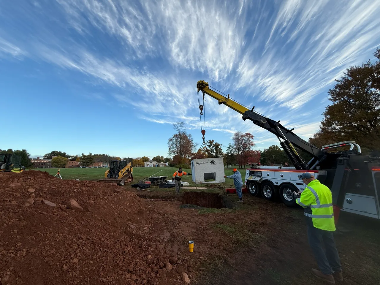 Crane truck unloading precast drainage structures