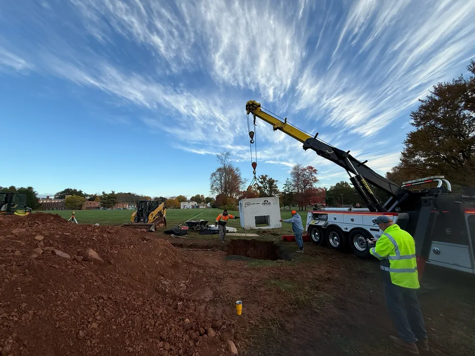 Crane truck unloading precast drainage structures