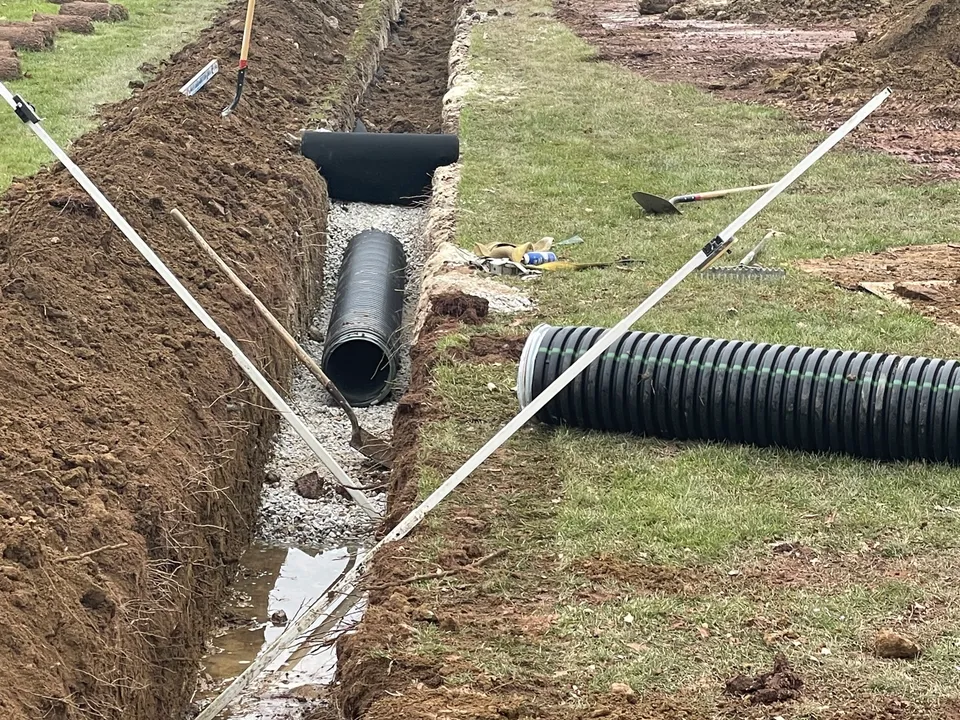 Drainage lines tied into a collector pipe under an athletic field