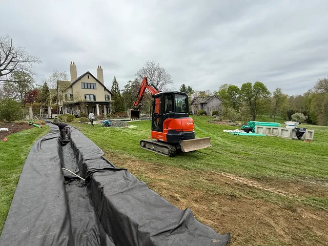 French drain trench lined with filter fabric across a yard