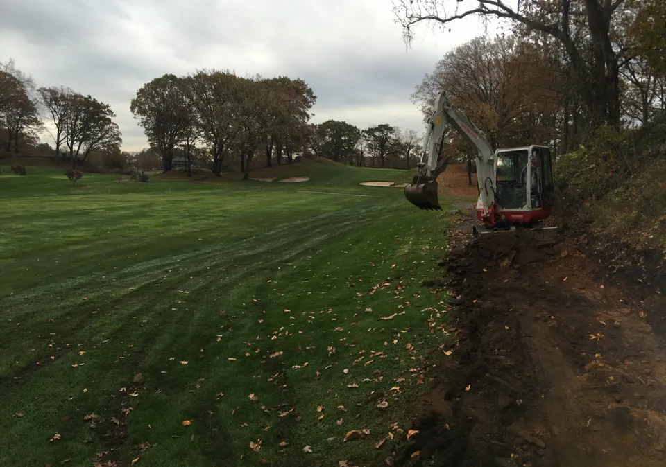 Trenching for drainage across a golf course fairway