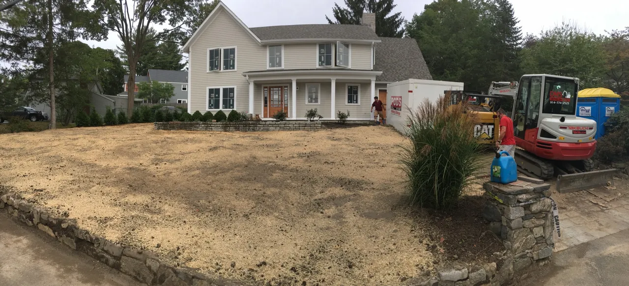Graded front yard with a new stone retaining wall