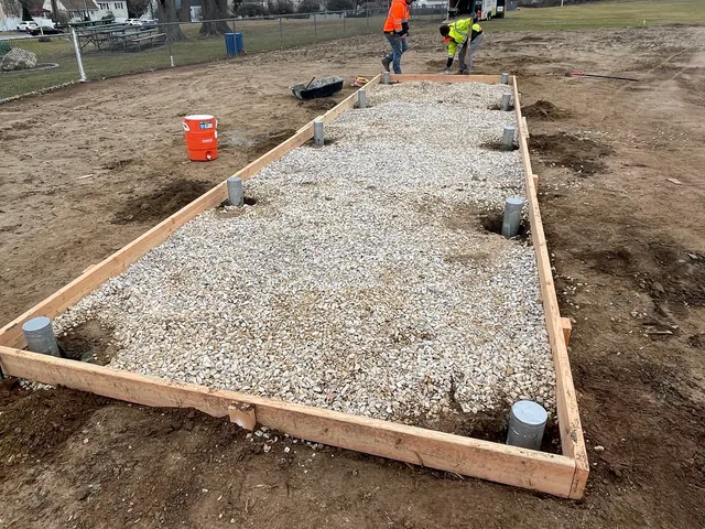 Gravel pad with drainage stubs set before the concrete pour