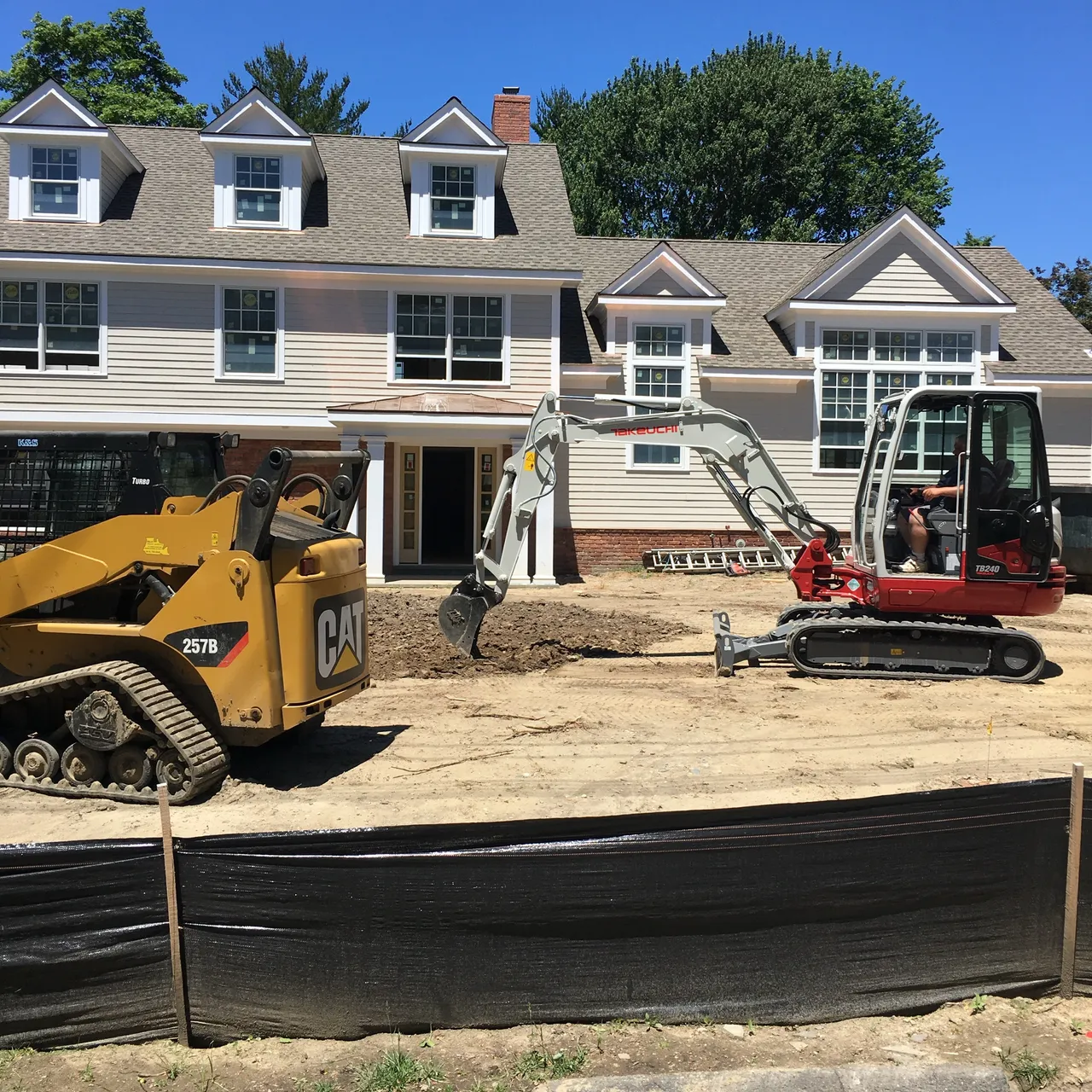 Excavation and site work at a new home, skid steer and excavator on site