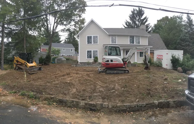 Residential excavation behind a new stone retaining wall