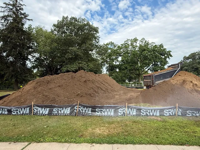 Soil stockpile behind silt fence on an active site