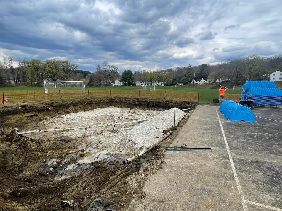 Excavation for an underground stormwater system beside a soccer field